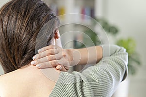 Young woman having neck pain