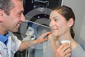 young woman having neck ultrasound examination at hospital