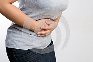 Young woman having painful stomachache. Chronic gastritis. Abdomen bloating and healthcare concept