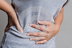 Young woman having painful stomachache. Chronic gastritis. Abdomen bloating and healthcare concept photo
