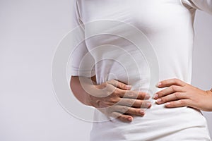 Young woman having painful stomachache. Chronic gastritis. Abdomen bloating and healthcare concept photo