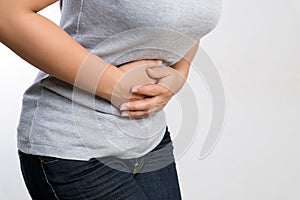 Young woman having painful stomachache. Chronic gastritis. Abdomen bloating and healthcare concept photo