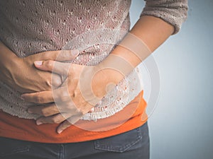 Young woman having painful stomachache. photo