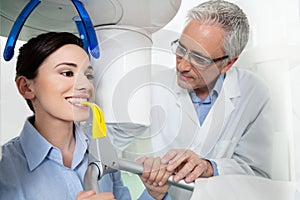 Young woman having panoramic digital X-ray with a the dentist photo