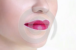 Young woman having permanent makeup on her lips at the beauticians salon