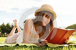 Young woman having picknic in park