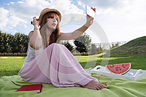 Young woman having picknic in park