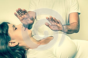 Young woman having reiki healing treatment - retro style