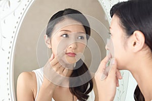 Young woman having skin problems