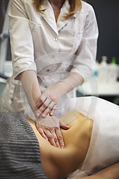 Young woman having stomach massage