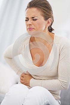 Young woman having stomach pain