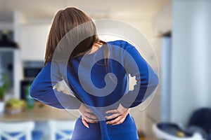 Young woman having suffering back ache