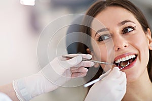 Woman having teeth examined at dentists photo
