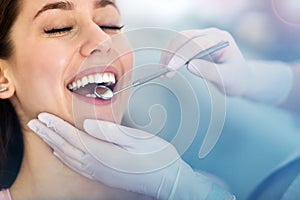 Woman having teeth examined at dentists photo