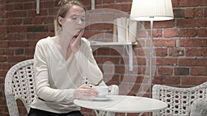 Young Woman having Toothache from Drinking Coffee