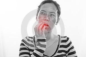 Young woman having toothache and touching mouth on isolated whi