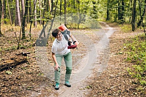 Young woman having trouble feeling knee pain during travel in forest. Injury on way to camp. female tourist got leg injury in