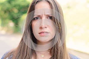 Young woman having uncertain and frustrated look.