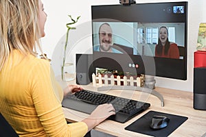 Young woman having video call party with friends using computer at home - Focus on right hand