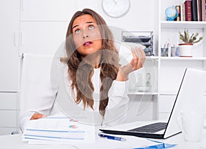Young woman having work troubles in office