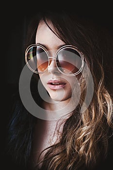 Young woman head shot, beautiful model portrait with big round sunglasses