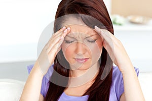 Young woman with headache at home