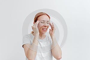 Young woman with headache. Pain in head, temple. Headache migraine,eye pain. White background