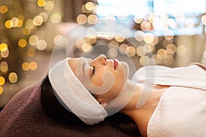 Young woman with headband lying in spa parlor