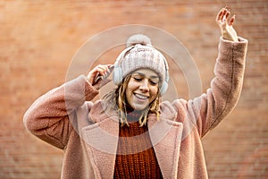 Young woman with headphones and cell phone