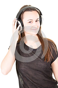 Young woman with headphones on head hand looks in camera