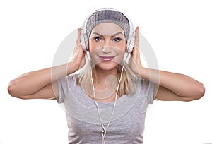 Young woman with headphones listening music, isolated on white