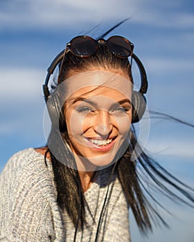 Young woman with headphones listening music outdoor