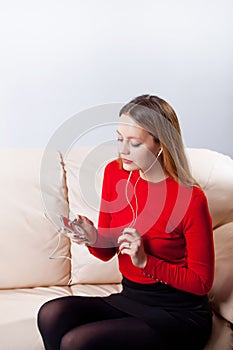Young woman in headphones listening music relaxing at home on so