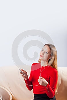Young woman in headphones listening music relaxing at home on so