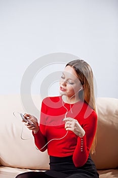 Young woman in headphones listening music relaxing at home on so