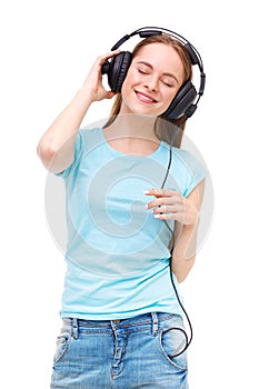 Young woman with headphones listening to music and dancing