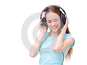 Young woman with headphones listening to music and dancing.