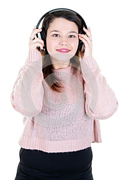 Young woman with headphones looks in camera in white background