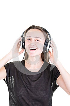 Young woman with headphones looks in camera on white background