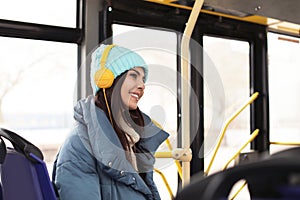 Young woman with headphones in public transport