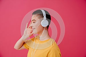 Young woman in headphones smiling while listening music