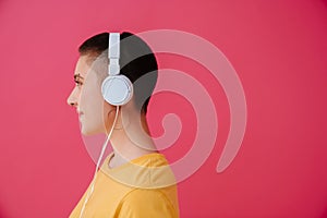 Young woman in headphones smiling while listening music