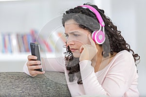 young woman with headphones using smart phone