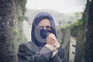 Young woman with headscarf in village