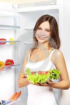 Young woman with healthy salad.