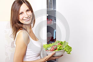 Young woman with healthy salad