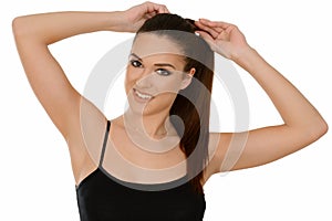 Young woman with healthy shining brown hairs put in pony tail.