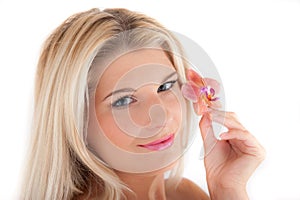 Young woman with healthy skin and flower