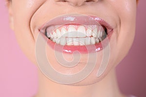 Young woman with healthy teeth and beautiful smile on color background