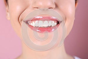 Young woman with healthy teeth and beautiful smile on color background